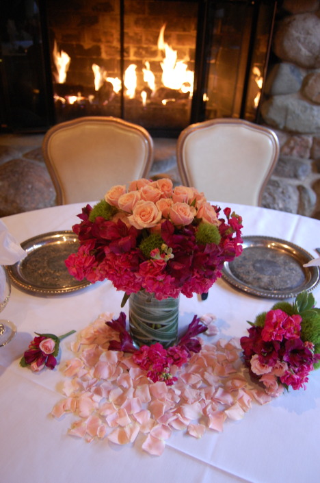 peach and red floral centerpiece on a table