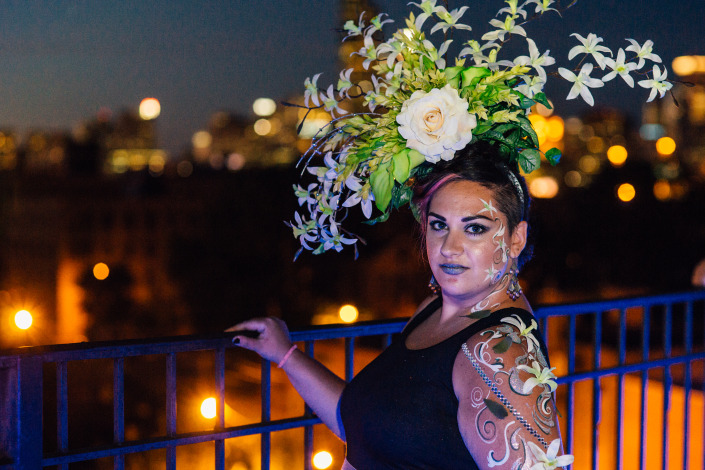 large floral headpiece on a woman outside at night