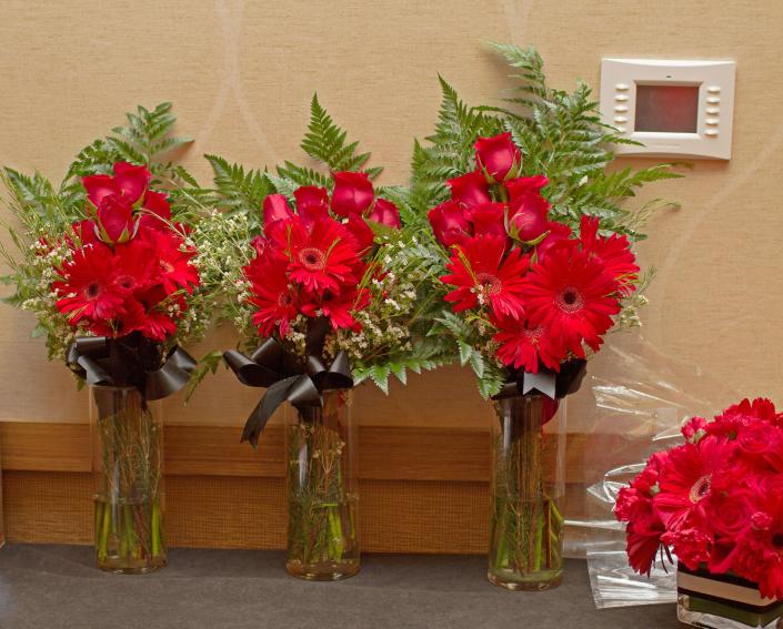 three large red bouquets of flowers
