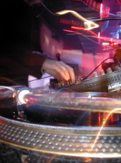 Hands of a DJ on a turntable